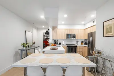 a kitchen and dining room with a table and chairs at 8 Santa Monica Huge Stylish Apartment in Los Angeles