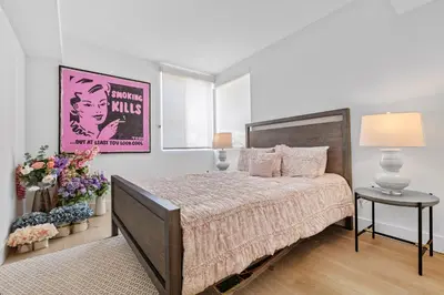 a bedroom with a large bed and a table at 8 Santa Monica Huge Stylish Apartment in Los Angeles