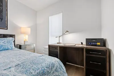 a bedroom with a bed and a desk with a computer on it at 8 Santa Monica Huge Stylish Apartment in Los Angeles