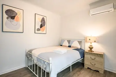 a small bedroom with a bed and a night stand at Comfortable Home Near LA with Full Kitchen & Laundry in Alhambra