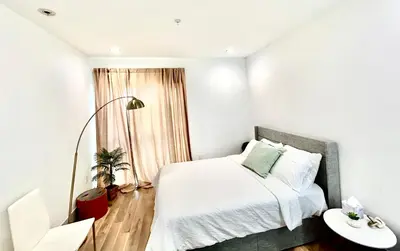 a bedroom with a bed and a table and a window at New Lux Skyline Loft in LA in North Sherman Way
