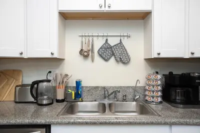 a kitchen counter with a sink and utensils at Sunny SoCal Escape 3BR 2BA Bright home with pool in Winnetka