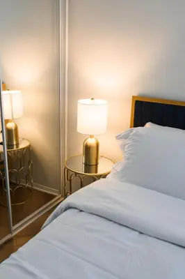 a bedroom with a bed and two tables with lamps at 2BDR Home Away From Home in Marina del Rey in Los Angeles