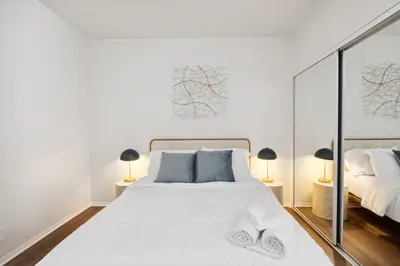 a bedroom with a large white bed with two lamps at 2BDR Home Away From Home in Marina del Rey in Los Angeles
