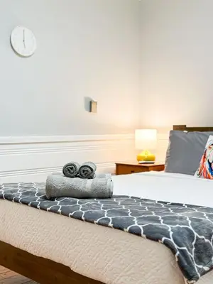 a bedroom with a bed with two towels on it at Elegant 4-Bedroom with Courtyard - WIL- BEV in Los Angeles