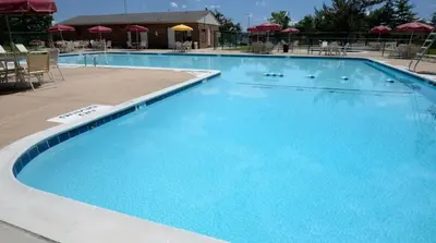 a large blue swimming pool with chairs and umbrellas at Relaxing space in Palos Verdes in Rancho Palos Verdes
