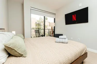 a bedroom with a bed and a large window at Magnificent two bedroom in West Hollywood in Los Angeles