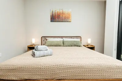 a bedroom with a large bed with two lamps at Magnificent two bedroom in West Hollywood in Los Angeles