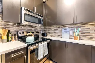 a kitchen with a stove and a microwave at Marina del Rey 1bdr Retreat with pool, gym, free parking in Los Angeles