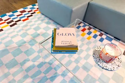 a glass table with a book and a plate with a candle at Marina del Rey 1bdr Retreat with pool, gym, free parking in Los Angeles