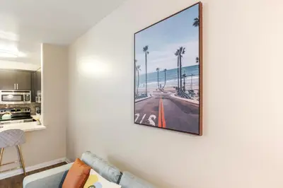 a living room with a picture of the beach on the wall at Marina del Rey 1bdr Retreat with pool, gym, free parking in Los Angeles