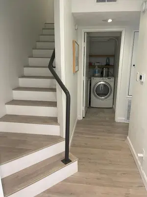 a hallway with a stairway with a washing machine at Luxe 2-BR with King suite, rooftop, steps from beach in Los Angeles