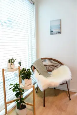 a room with a chair with a white fur seat at King Oasis - steps to beach with garden patio! in Los Angeles