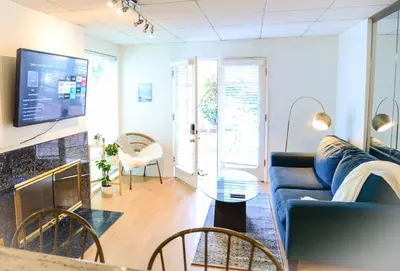 a living room with a couch and a table at King Oasis - steps to beach with garden patio! in Los Angeles