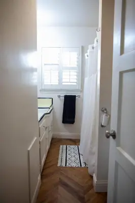 a bathroom with a window and a shower curtain at Historic, Family-Friendly Home in Downtown in Bakersfield