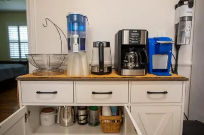 a kitchen counter with a coffee maker on it at Historic, Family-Friendly Home in Downtown in Bakersfield
