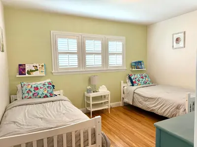 a bedroom with two beds and a window at Historic, Family-Friendly Home in Downtown in Bakersfield
