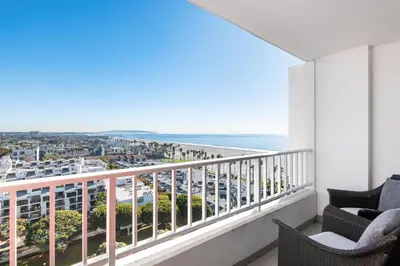 a balcony with chairs and a view of the beach at The violet-Santa Monica highrise beach front&view in Los Angeles