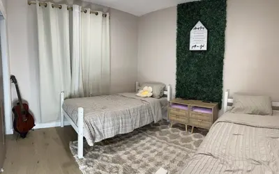 a bedroom with two beds and a guitar in it at Luxury Home LA Big Bear & LV 5 Mins to Mall in Victorville
