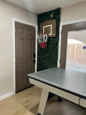a ping pong table in a room next to a door at Luxury Home LA Big Bear & LV 5 Mins to Mall in Victorville
