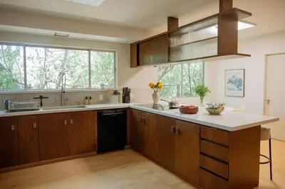 a kitchen with wooden cabinets and a large window at Villa Mountain Getaway with a Pool Hot Tub 5 Beds in Los Angeles