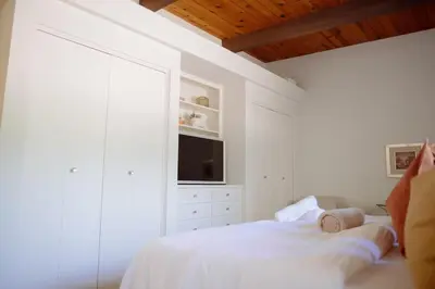 a white bedroom with a bed and a television at Villa Mountain Getaway with a Pool Hot Tub 5 Beds in Los Angeles