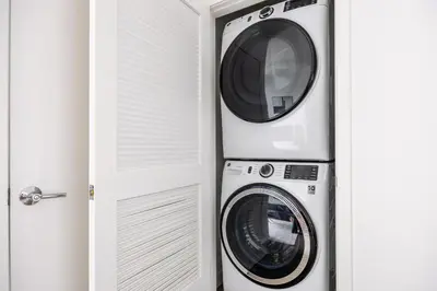two washing machines sitting next to a door at Blueground San Pedro AC balcony nr USS Iowa LAX-1301 in Los Angeles