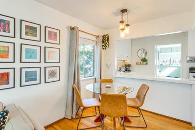 a kitchen and dining room with a table and chairs at 2 Mi to Griffith Park Chic Home with Private Patio in Burbank