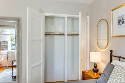 a bedroom with a closet with a bed and a mirror at 2 Mi to Griffith Park Chic Home with Private Patio in Burbank