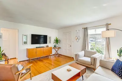 a living room with a couch and a tv at 2 Mi to Griffith Park Chic Home with Private Patio in Burbank