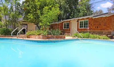 a swimming pool in front of a house at In The Village With Private Entrance in Claremont
