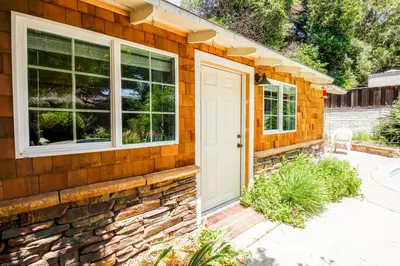 a brick house with a white door and windows at In The Village With Private Entrance in Claremont