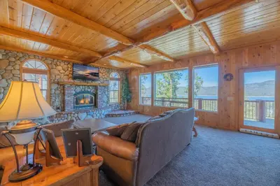 a living room with a couch and a fireplace at Valley View Cabin in Big Bear Lake