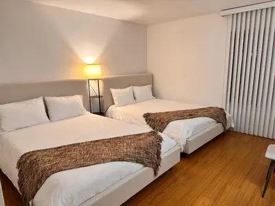 a hotel room with two beds and a lamp at Coastal haven retreat in Los Angeles