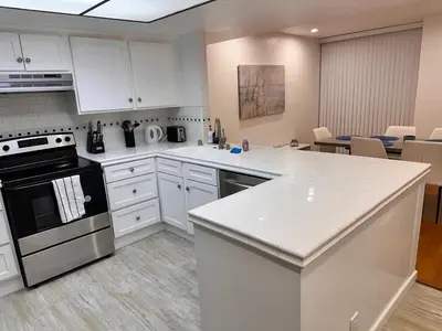 a kitchen with white cabinets and a stove at Coastal haven retreat in Los Angeles