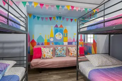 a bedroom with bunk beds with a disney mural at Mickeys House by OC Adventure Homes in Anaheim
