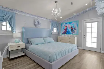 a blue bedroom with a bed and a chandelier at Mickeys House by OC Adventure Homes in Anaheim