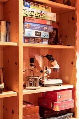 a book shelf filled with lots of books at Contemporary Classic on a Private Mountain Lake in Lake Arrowhead