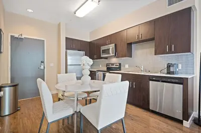 a kitchen and dining room with a table and chairs at Chic 1BR Retreat with Pool, Gym & Jacuzzi in Mid Wilshire & Miracle Mile in Los Angeles