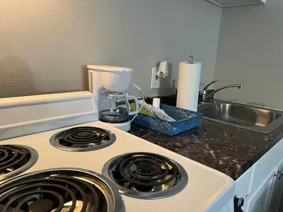 a kitchen counter with a stove and a sink at NoHo Cozy Cove in Burbank