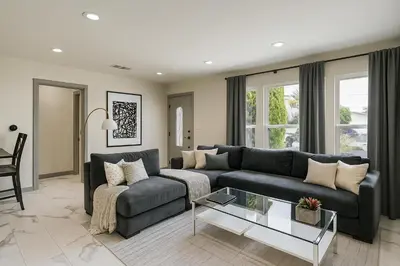 a living room with a couch and a table at The Pacific Nest - 10min from LAX in Hawthorne