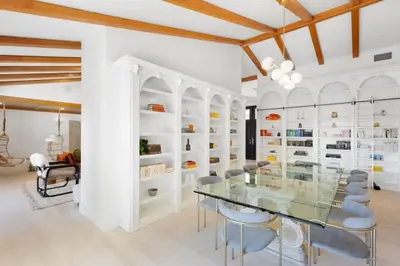 a dining room with a glass table and chairs at Malibu Park by Stay Awhile Villas in Malibu
