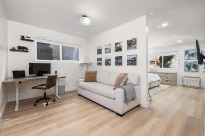 a white living room with a desk and a couch at The South Bay Retreat in Redondo Beach