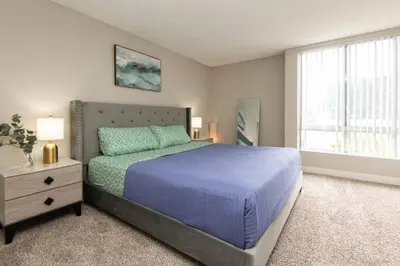 a bedroom with a blue bed and a window at Snazzy 2Bd Apartment Rooftop Pool & Iconic Hollywood Sign Views in Los Angeles