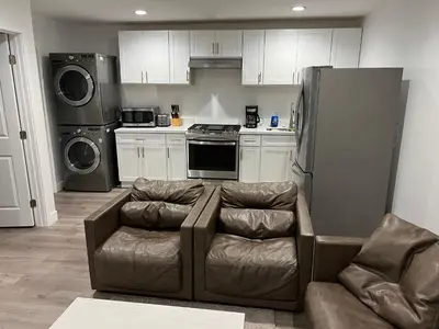 a living room with a couch and a refrigerator at Private gated 1bed & 1bath amazing for 2 in Los Angeles near Universal studio & Hollywood in Van Nuys Airport