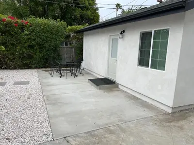 a patio with a table and chairs next to a building at Private gated 1bed & 1bath amazing for 2 in Los Angeles near Universal studio & Hollywood in Van Nuys Airport