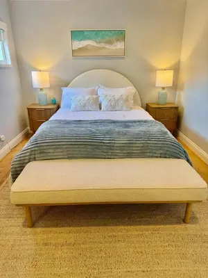 a bedroom with a large bed with two lamps at Sea La Vie Beachhouse on the sand in Long Beach