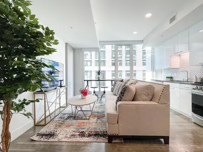 a living room with a couch and a table at Suite Downtown Pool and Gym Access in Los Angeles