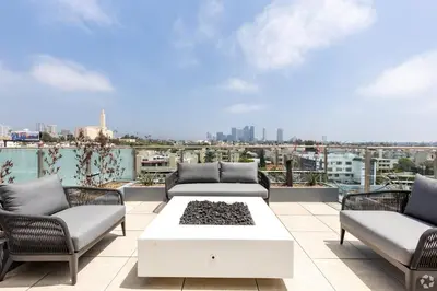 a patio with couches and a table on a roof at 3 Bedroom 2 Bath Westwood Condo in Los Angeles