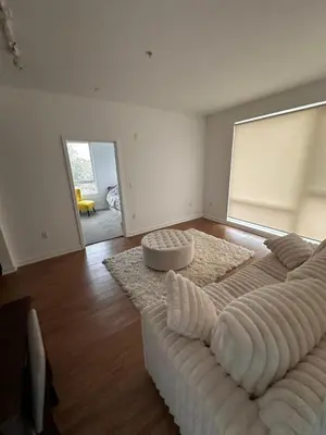 a living room with a large bed with a couch at Modern Unit Near Glendale Galleria and Walk to Shopping & Dining! in Glendale